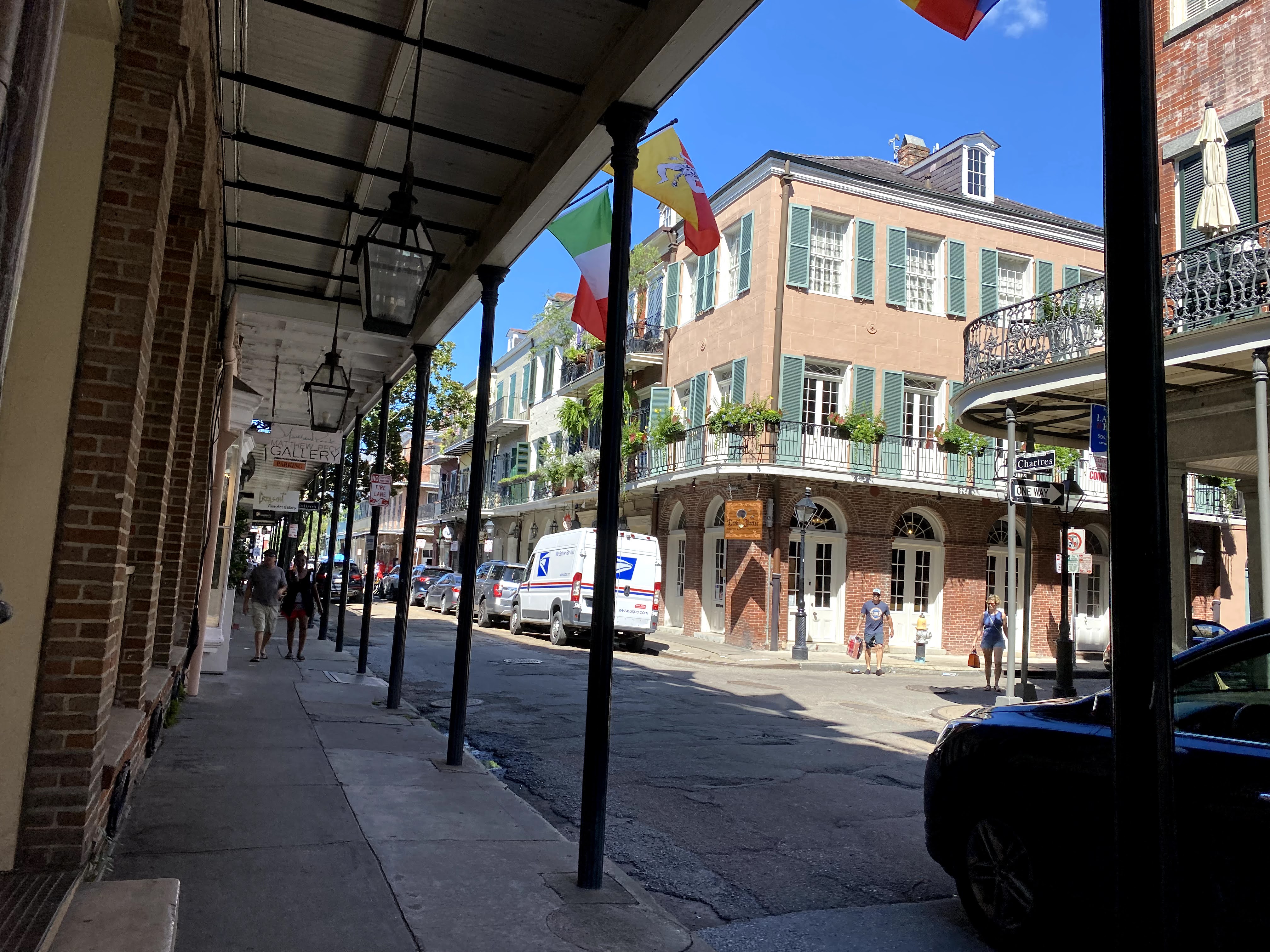 French Quarter balconies, green shutters, and shaded sidewalks